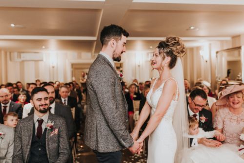 Couple in Woodhall manor cherry blossom room ceremony room