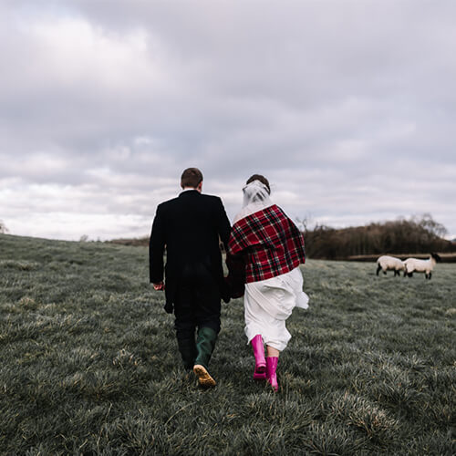 Couple walking through field