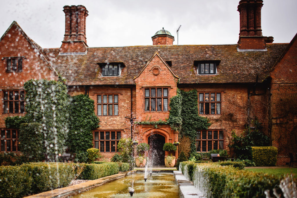The outside of Woodhall Manor with their fountains at the front