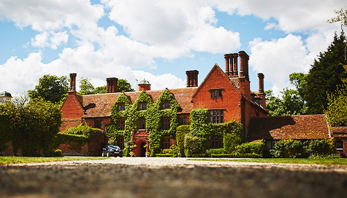 The front of Woodhall Manor with wedding car