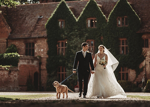 couple with dog outside woodhall manor
