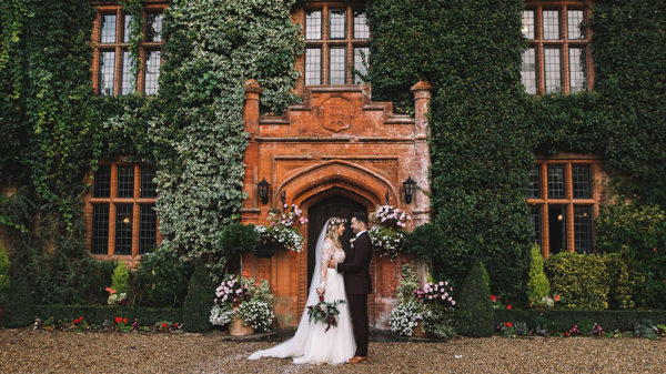 bride and groom boho style at woodhall manor entrance